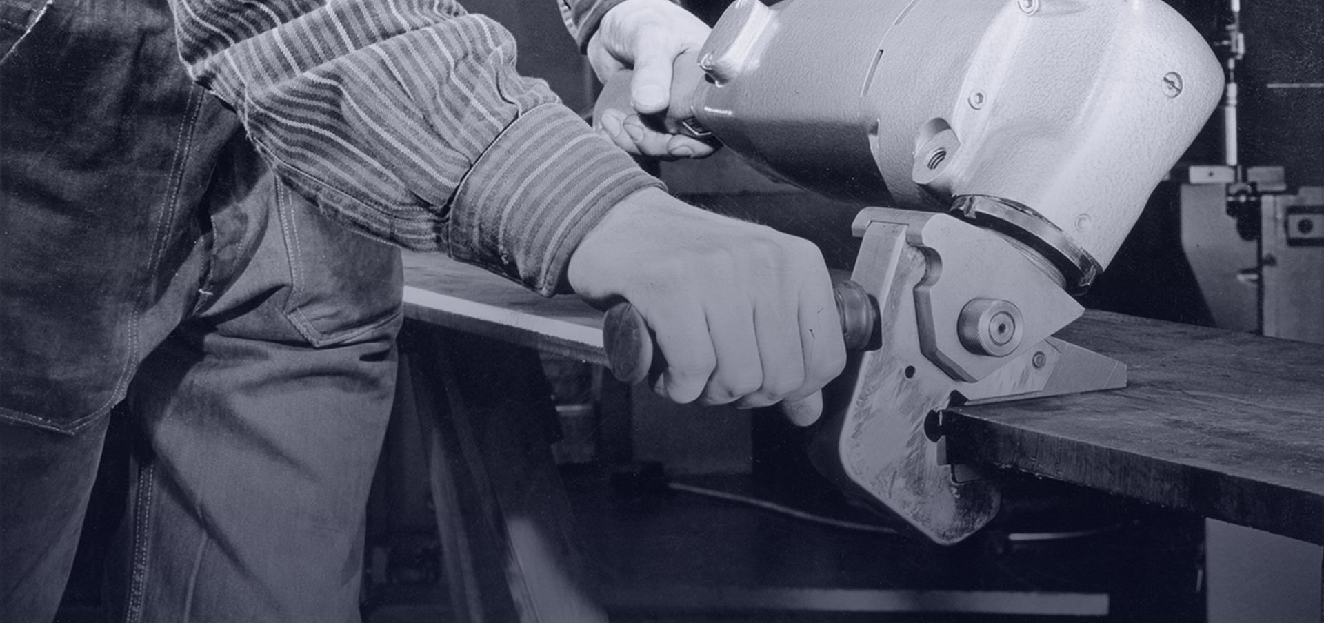 historical picture showing a worker with a deburrer